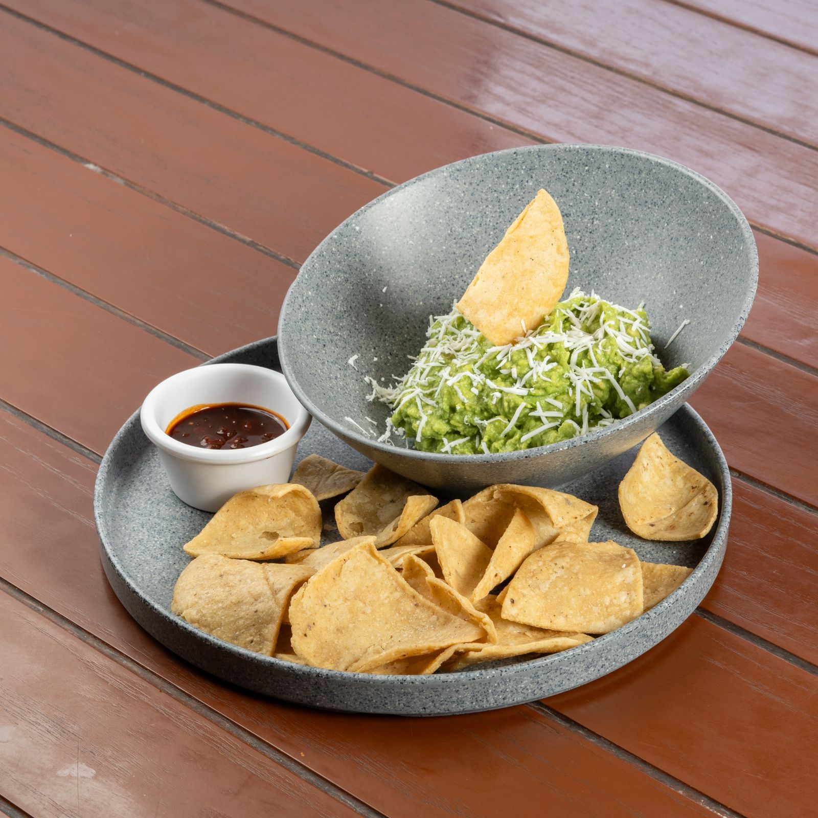 Fresh guacamole with tortilla chips and salsa