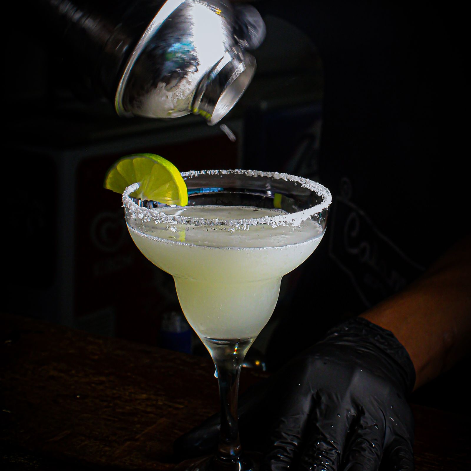 Freshly poured margarita with a salted rim and lime wheel