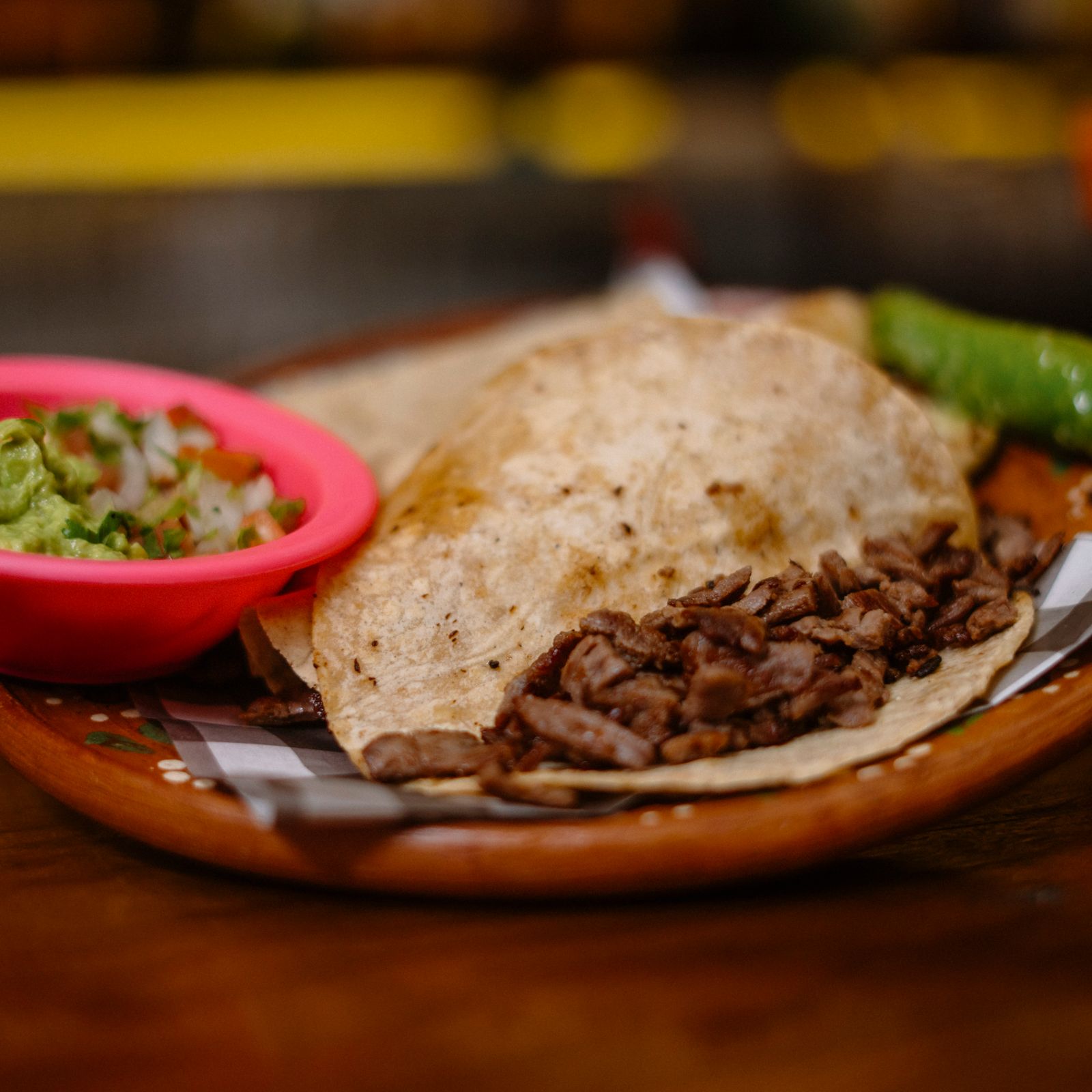 Handmade street taco with grilled beef, guacamole and salsa