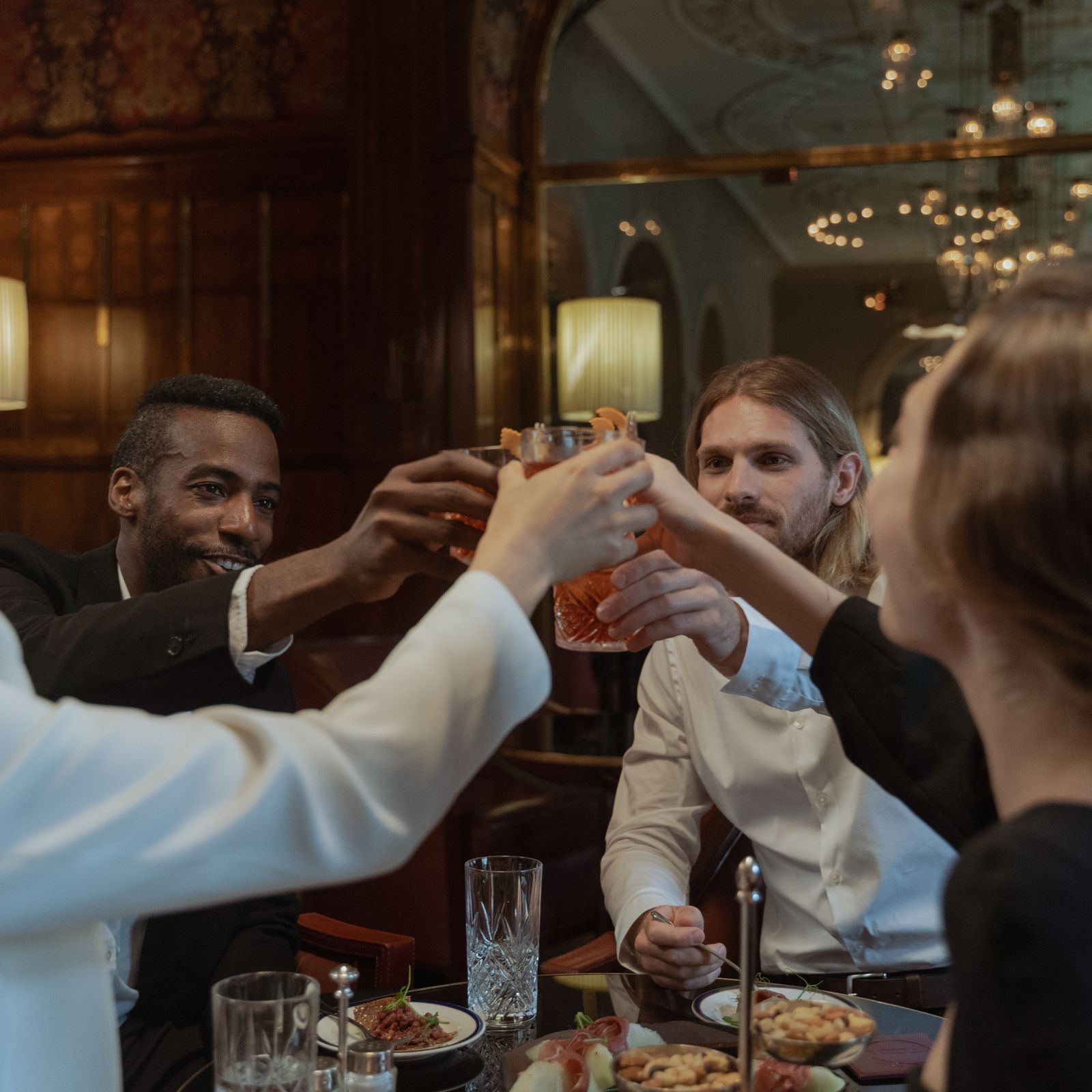 Friends raising a toast around a restaurant table